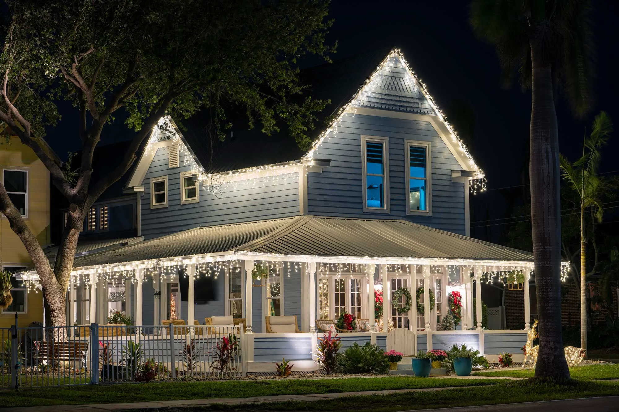 Home exterior decorated with holiday lighting.